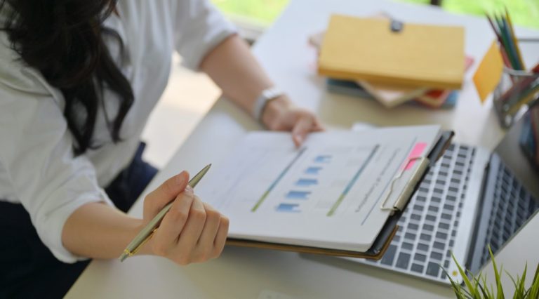Person reviewing financial documents and credit reports at desk